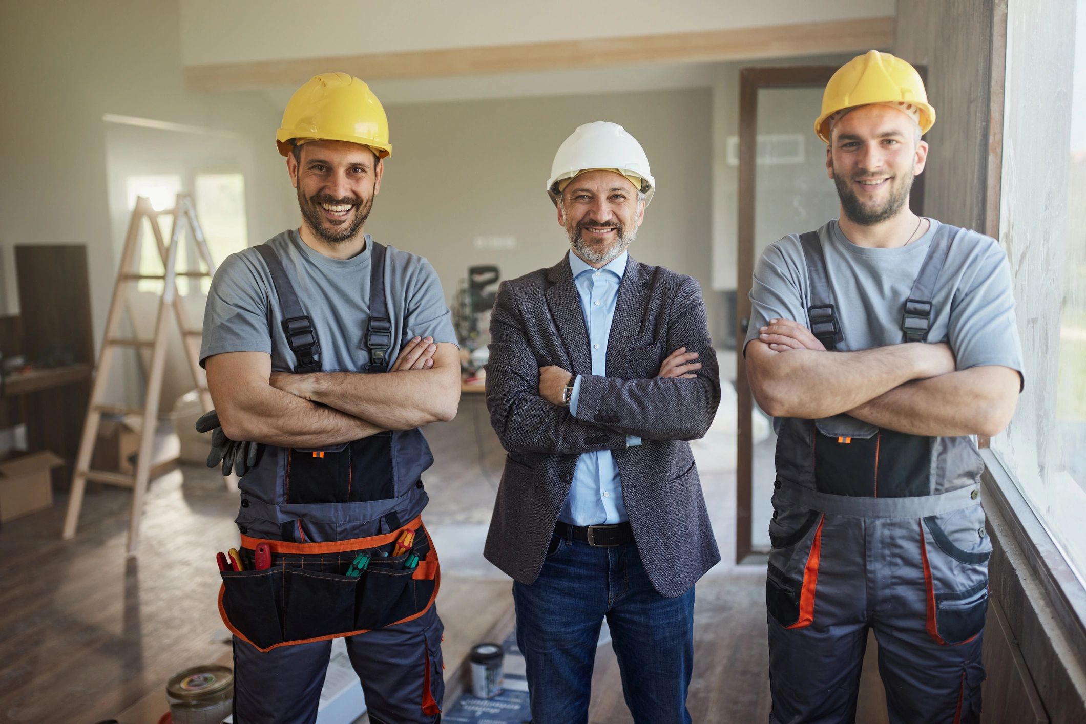 Refurbishment team and designer standing together on a renovation site